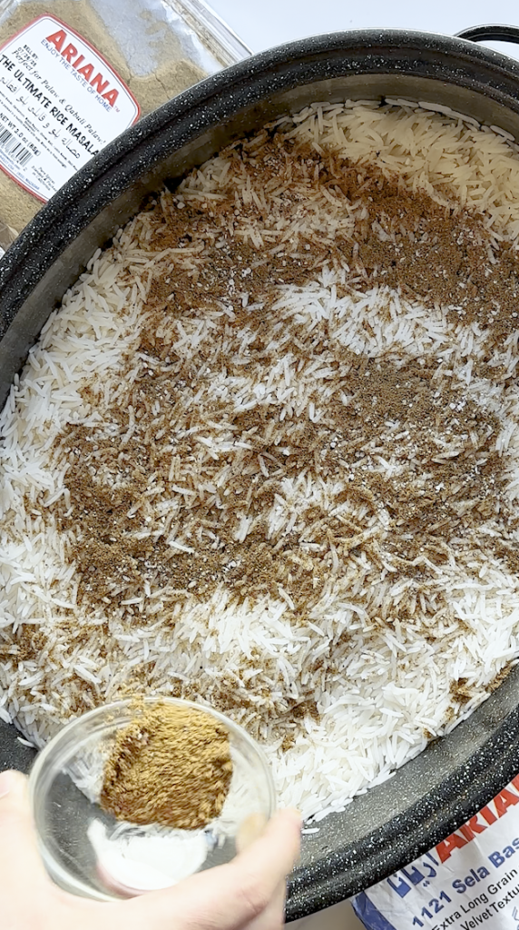 brown rice being seasoned for Kabuli palaw